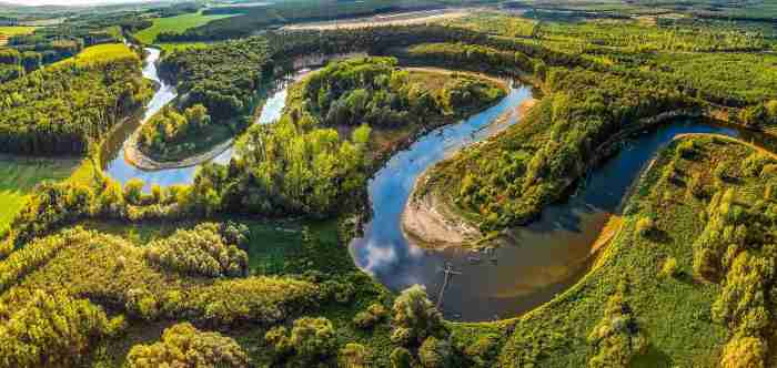 Geological features formed by rivers crossword